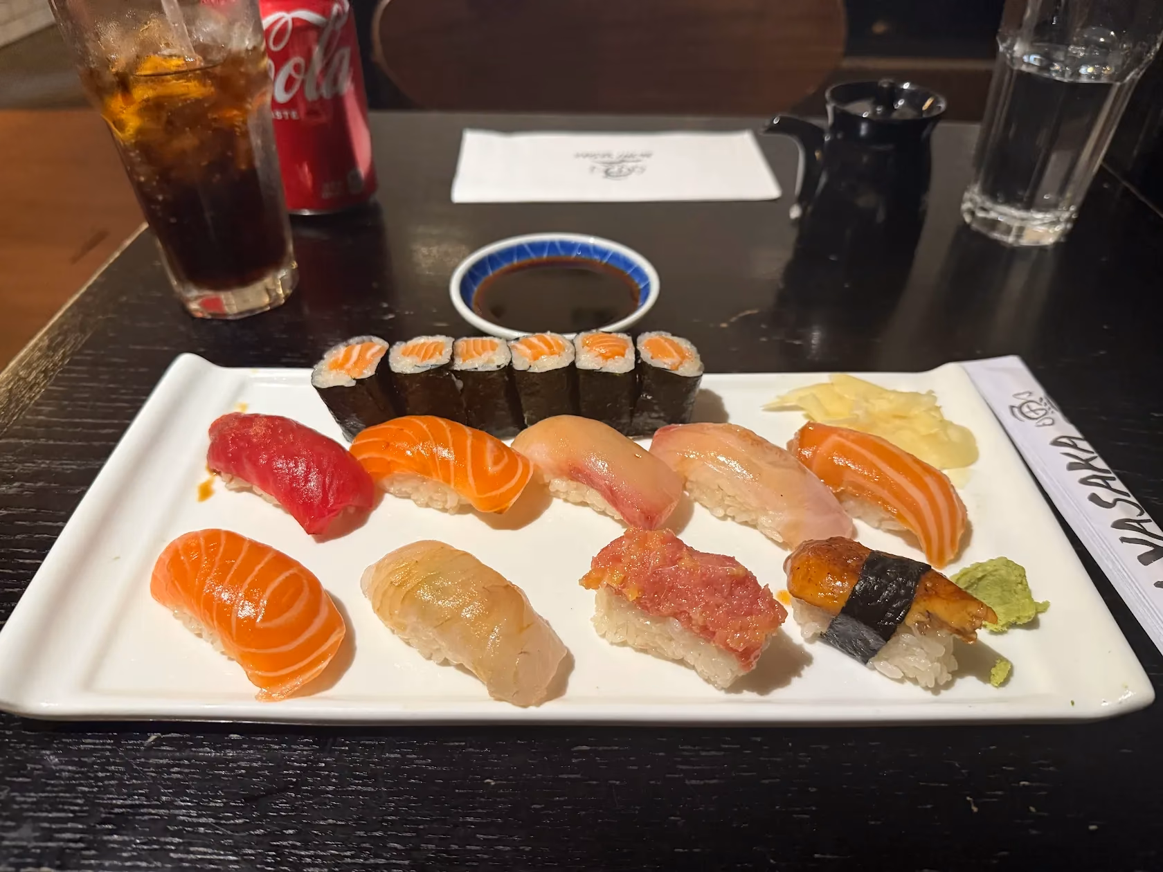 Assorted nigiri and a roll on a Yasaka plate